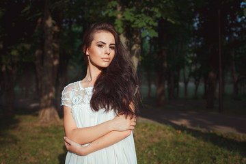 beautiful girl in a white dress on nature