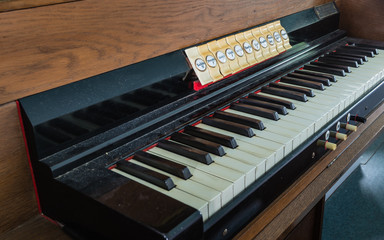 Fototapeta na wymiar Old and dusty organ keyboard from close
