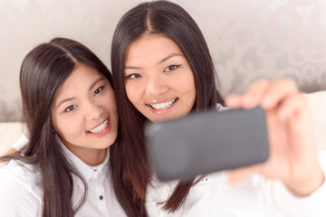 Two Asian girls doing selfie
