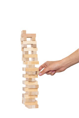 Hand playing in jenga on white background