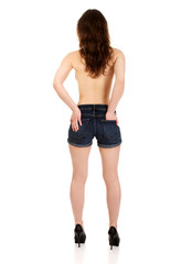Shirtless woman in jeans shorts.