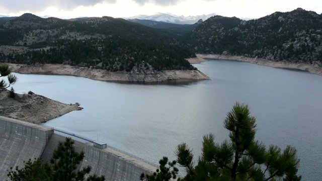 Pan across a mountain lake to the dam
