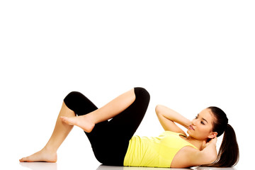 Fototapeta premium Woman exercising and doing a crunch.