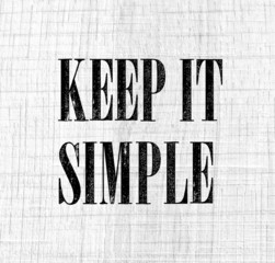 Keep it simple phrase on white vintage wood background