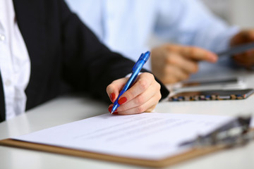 Young woman sitting  at the desk with folder