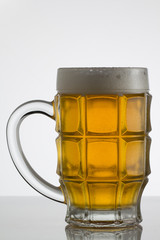Glass of beer on white background