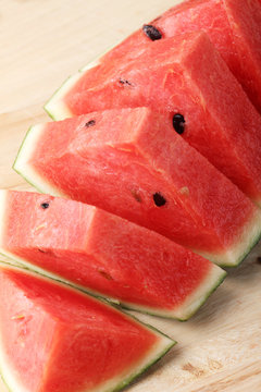 Slices of watermelon on wooden background