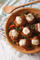 Meatballs baked with cheese close up vertical top view
