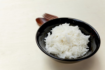 Closeup rice bowl with space on wood background