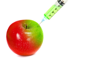 injection green into red fresh apple with syringe