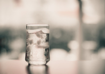 glass of Cool fresh drink with ice cube on the  table