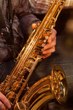 The saxophone in the hands of the musician
