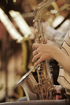 Hand girl playing the saxophone 
