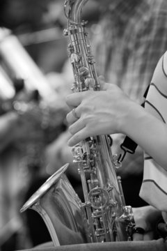 Hand girl playing the saxophone in black and white 
