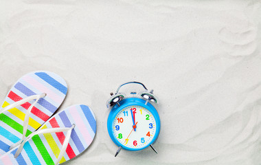 Colorful flip flops and classic alarm clock