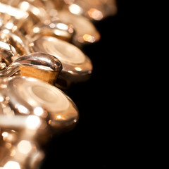 Fragment of a flute closeup on black background