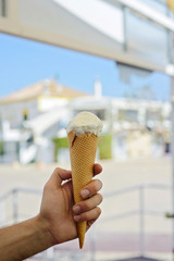 Hand holding pink ice-cream