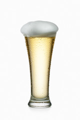 Light beer into glass isolated on white