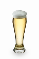 Light beer into glass isolated on white