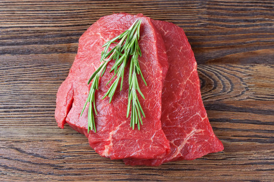 raw beef steak with rosemary