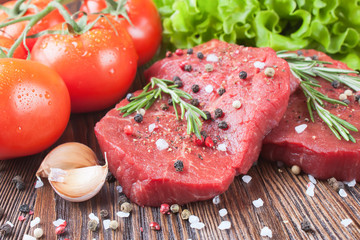Raw beef steak with vegetables and spices 