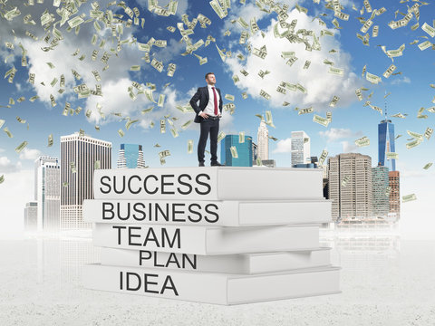 student standing on top of books