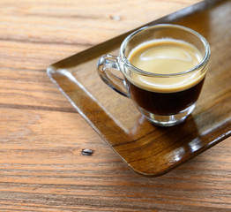 Cup of espresso coffee on wood tray