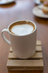 capucino coffee on wood background