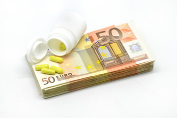 Money pile Euro 50 banknotes with medicine pills