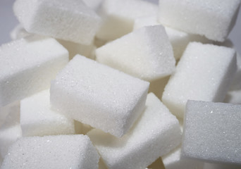 isolated pile of sugar cubes close up view in diet concept
