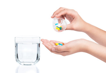 Druge capsules and pills in hand with drinking water - 84252806