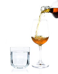 pour whisky into glass and drinking water