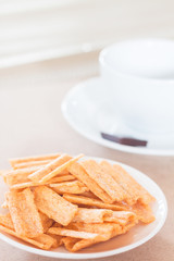 Fototapeta na wymiar Snack on white plate with coffee cup