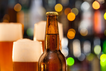 Jug of beer with bottle served on bar counter