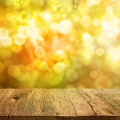 Wooden table with autumn background