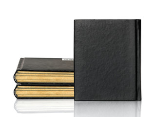 Closed black book is laying on white background