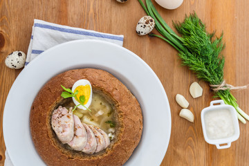Polish rye soup with eggs and sausage in bread