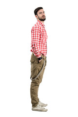 Side view of young bearded hipster with head leaned back