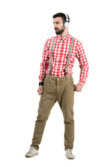 Young hipster with retro headphones looking away