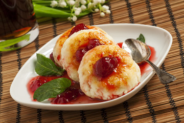 Homemade cottage cheese pancakes with strawberry jam, selective