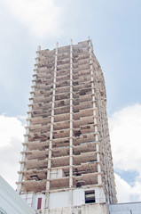Abandoned hotel against blue cloudy sky