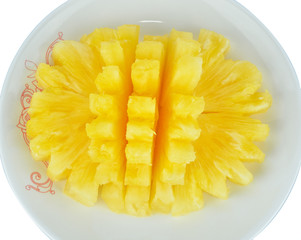 Pineapple chunks in the dish isolated on white