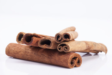 group of dried cinnamon stics on white background