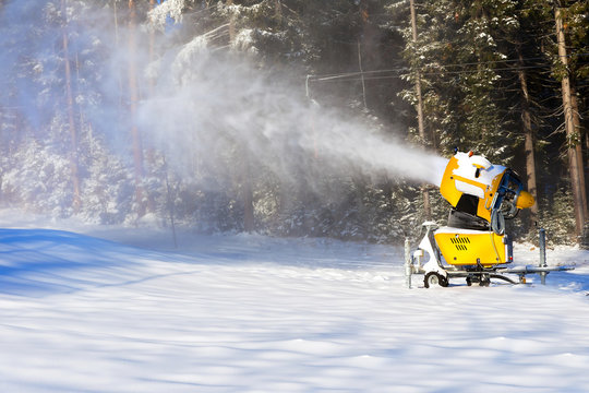 Snow gun on the background of the winter forest