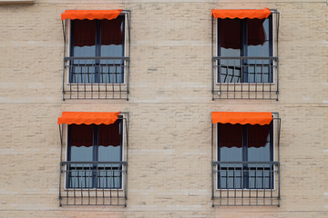 Fototapeta na wymiar Facade Of Building With Orange Awning