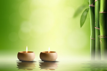 Zen concept. Two candles in bamboo forest.