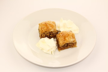 Traditional Turkish Ramadan dessert baklava with whipped cream 