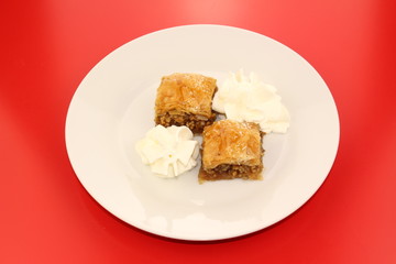 Traditional Turkish Ramadan dessert baklava with whipped cream 