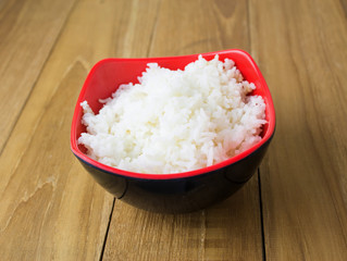 ripe rice in bowl on wooden board