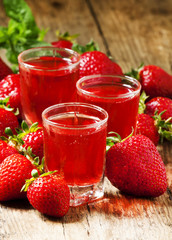 Clear fresh cold strawberry juice, selective focus